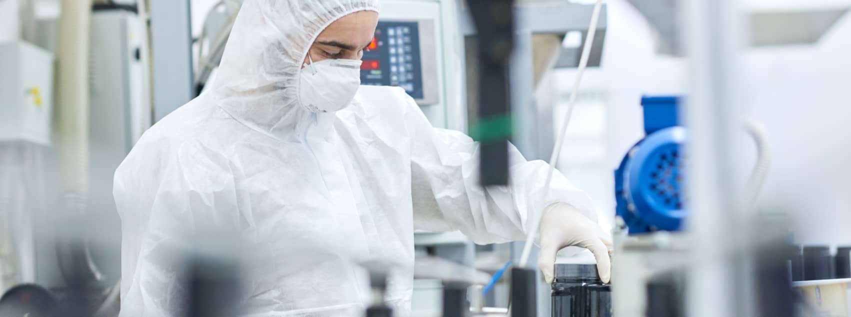 Operator in PPE inspecting filtration equipment