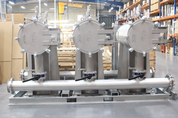 A containerised filtration system inside a clean and tidy warehouse